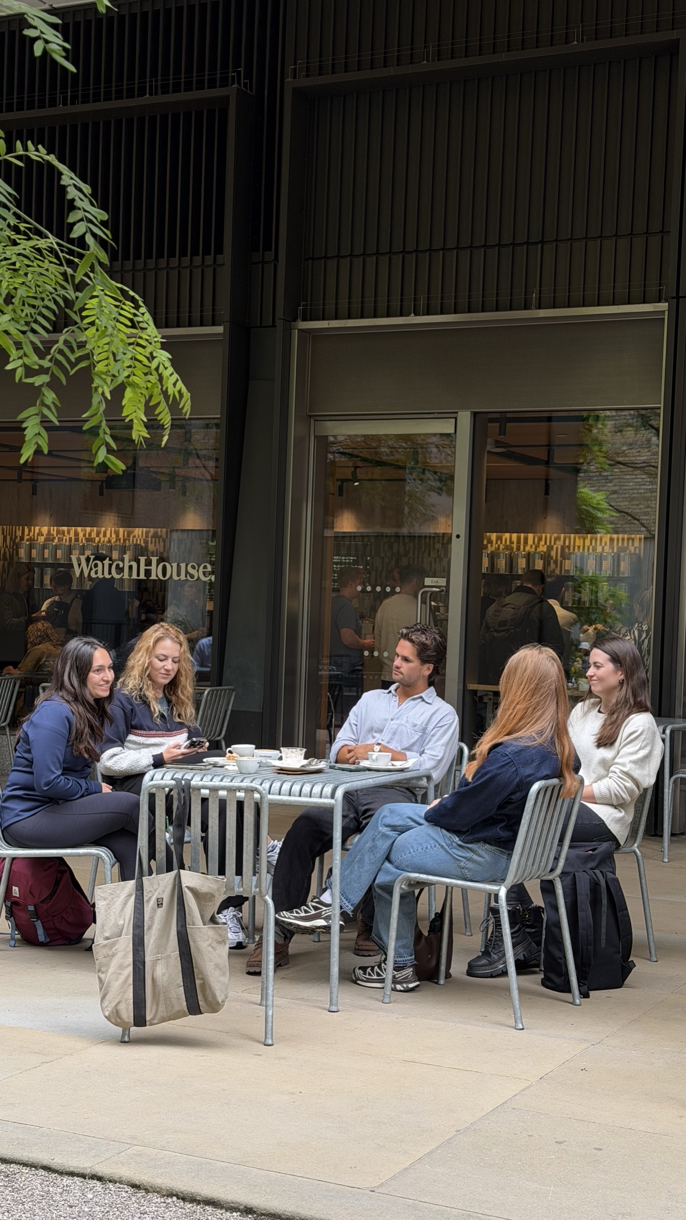 The Mood Booster community sitting outside WatchHouse Hanover with coffee