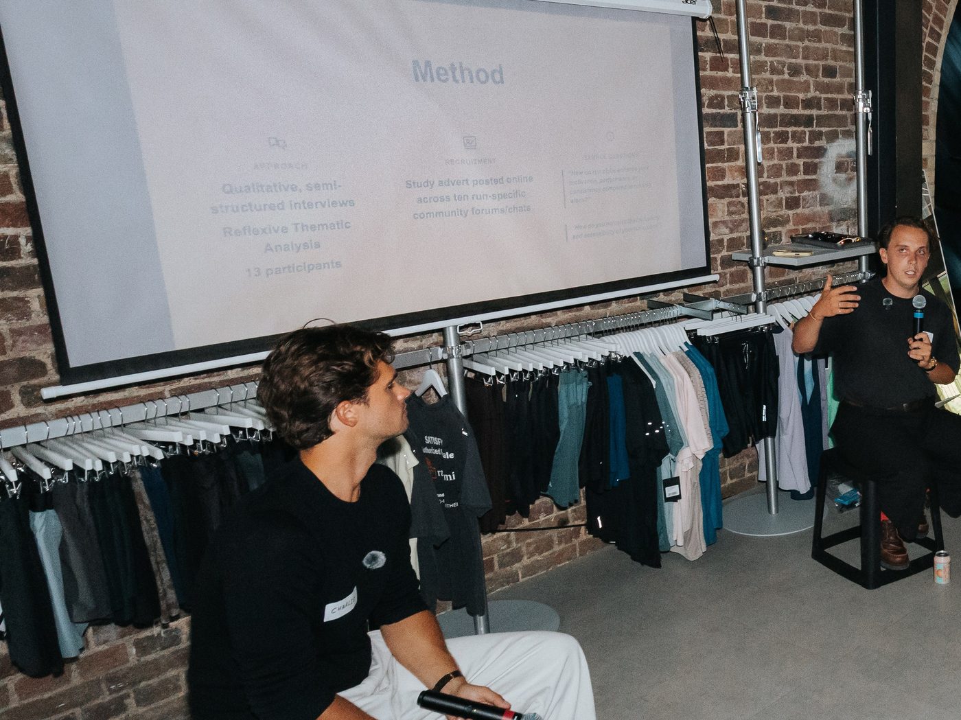 Two presenters discussing research findings