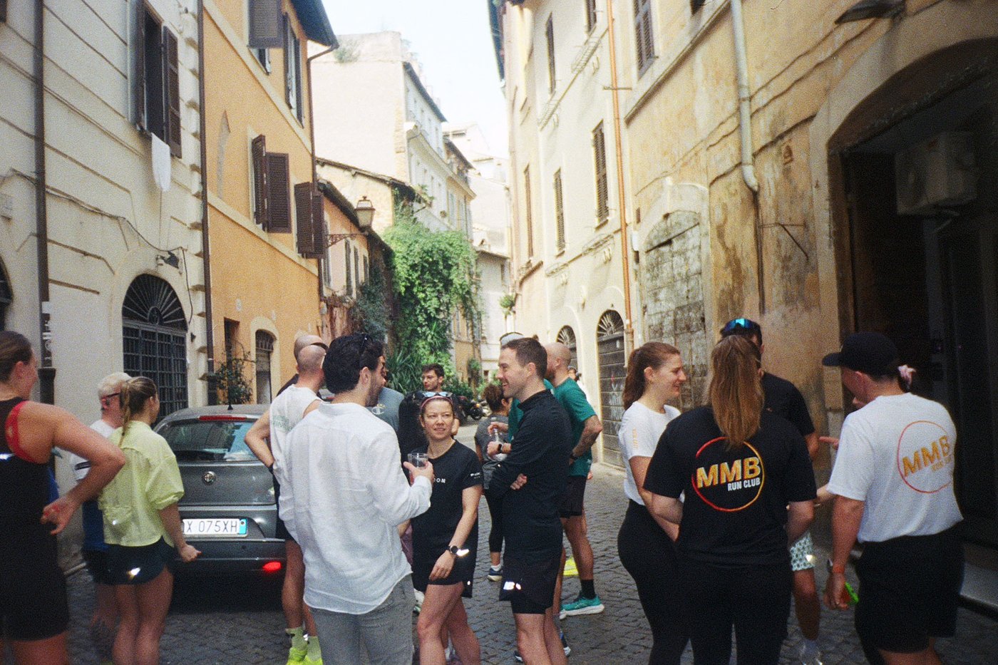 A group of runners talking together, present in the moment